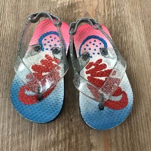 A pair of infant sandals.